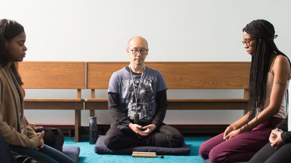Dr. Lin meditating with students.