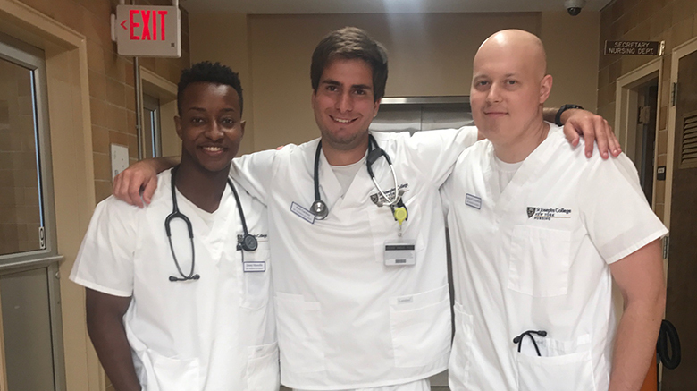 Frank with two SJC Long Island nursing students.