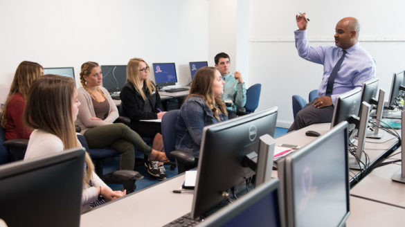 Professor in classroom with students.