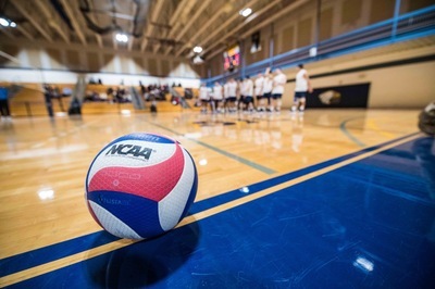 A volleyball on the floor of the SJC Long Island gym.