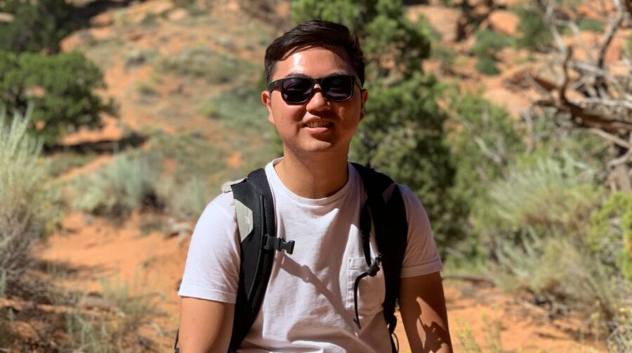 Student in desert with sunglasses.
