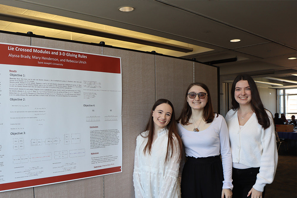 Students with their poster at the Student Research Symposium.